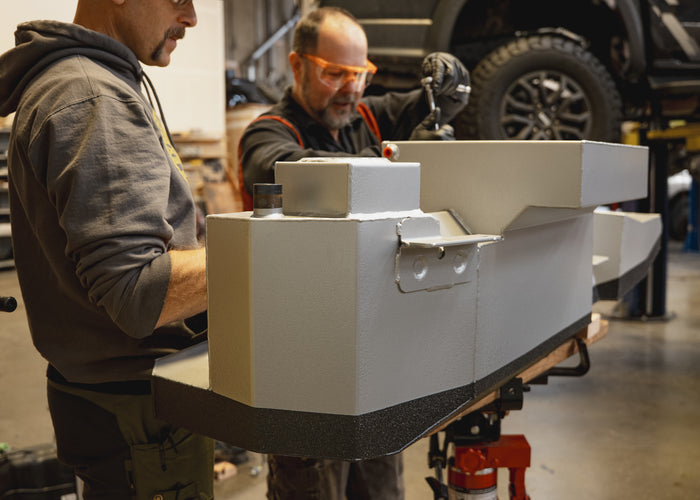 Mule technicians installing long range fuel tank